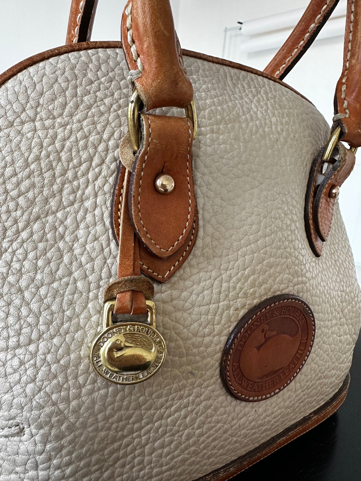 90s Dooney and Bourke Norfolk satchel in cream