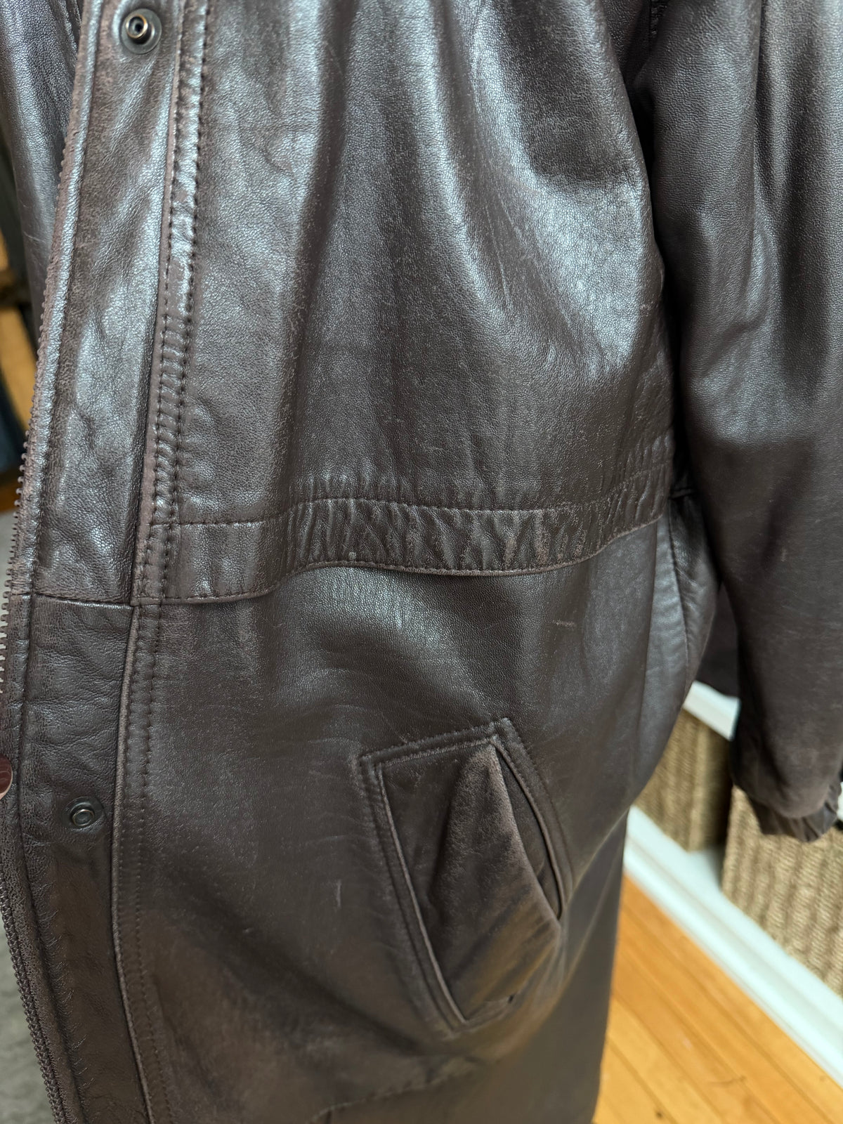 80s Tibor leather trench with zip out insulation and a zip off leather hood with real fur trim. Made in the USA. Fits S-L