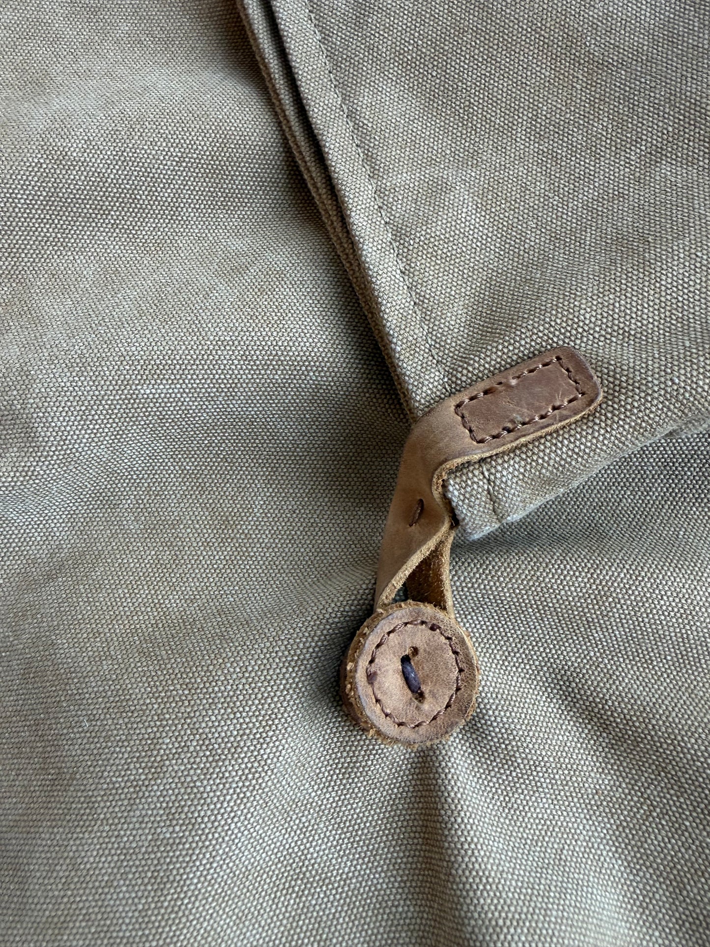 Crossbody canvas satchel with leather strap and closure