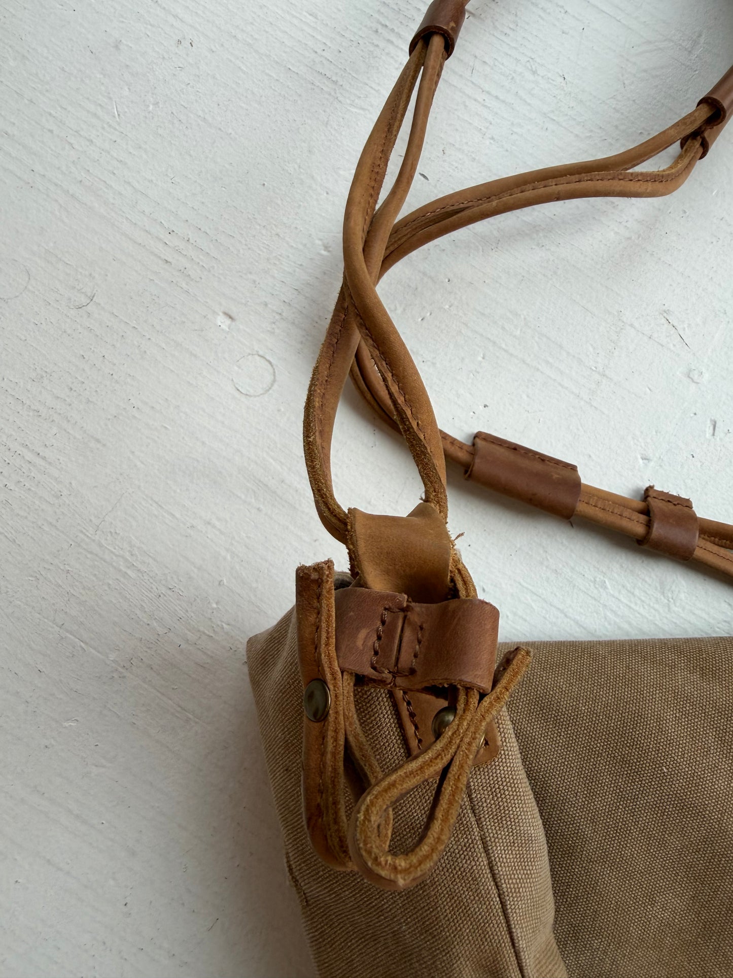 Crossbody canvas satchel with leather strap and closure