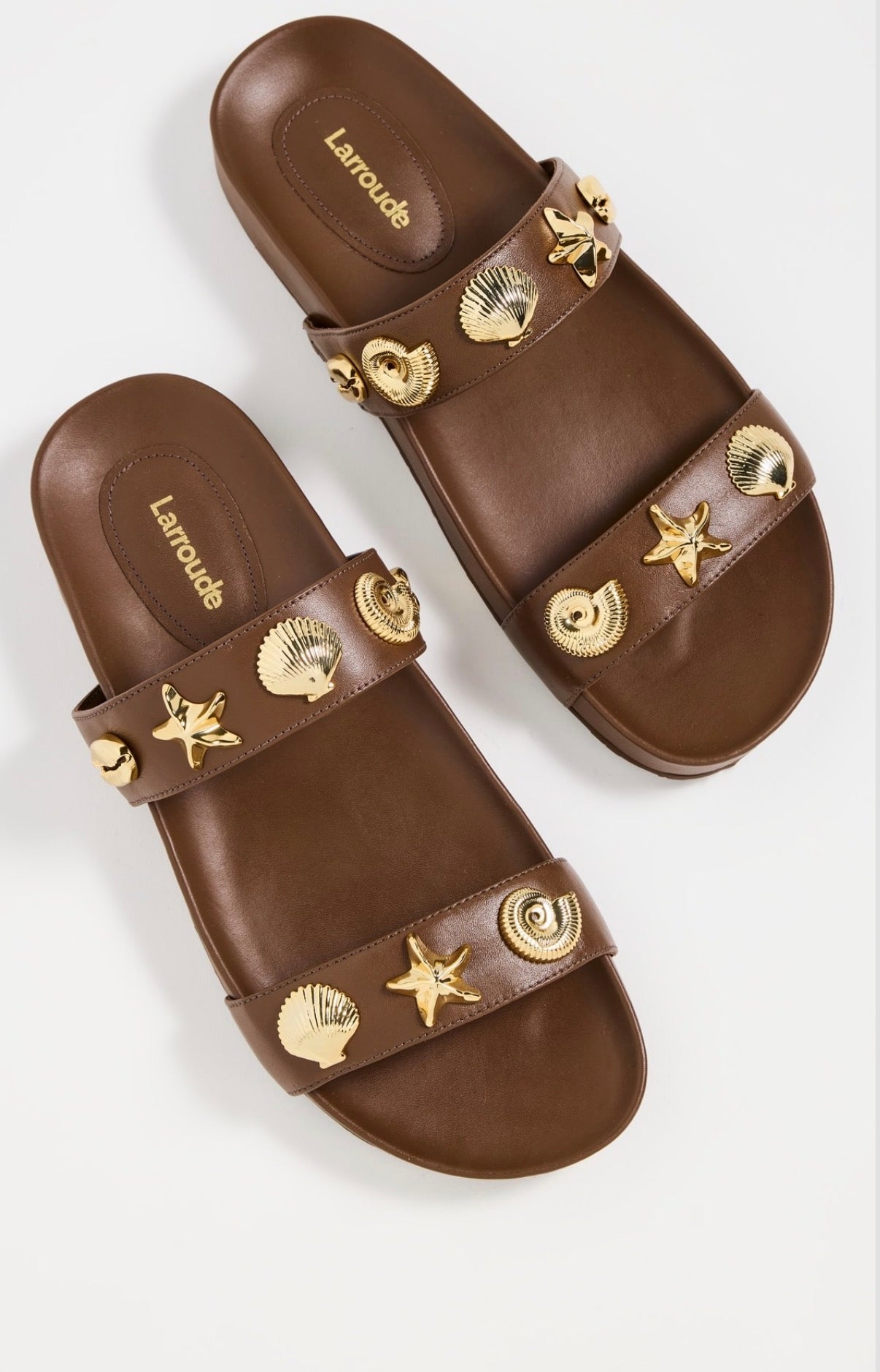 Larroude Madison Slide Sandals in brown leather, featuring gold-toned starfish and seashell hardware. Size 9