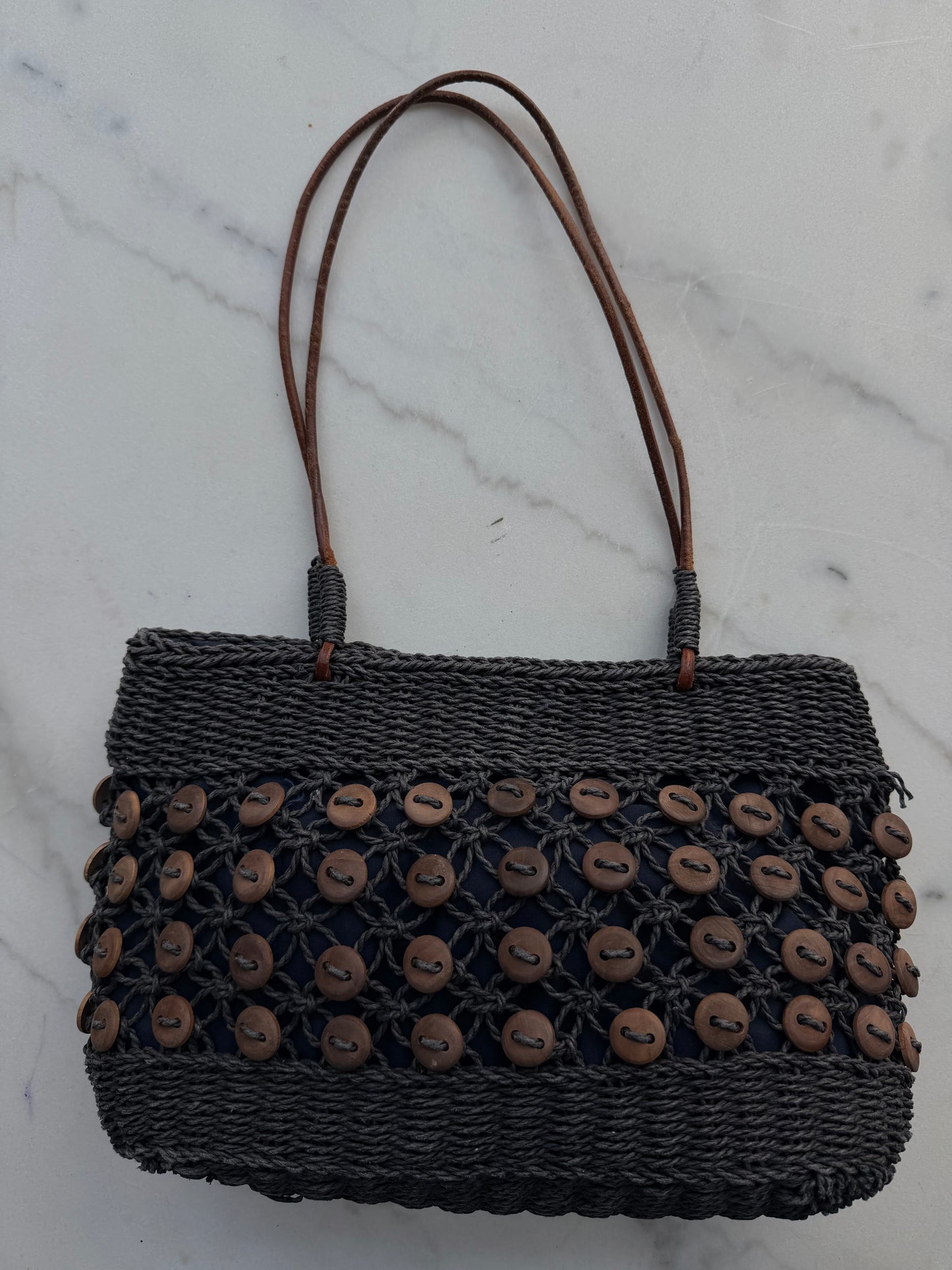 Vintage navy woven bag with wooden buttons and leather straps. Made in France