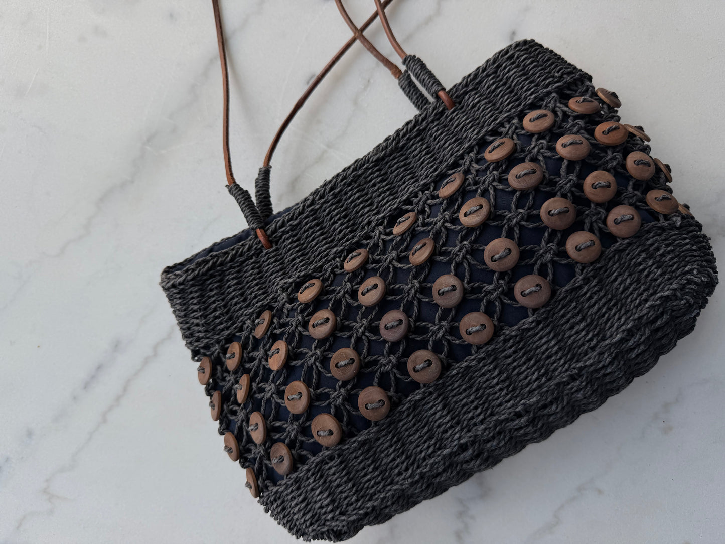 Vintage navy woven bag with wooden buttons and leather straps. Made in France