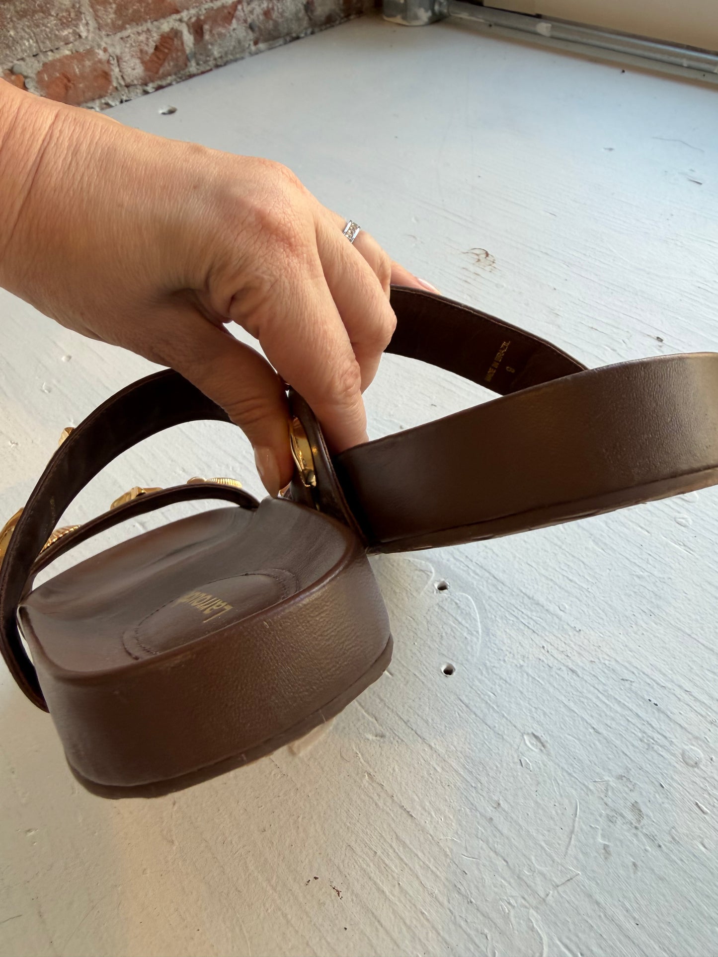 Larroude Madison Slide Sandals in brown leather, featuring gold-toned starfish and seashell hardware. Size 9