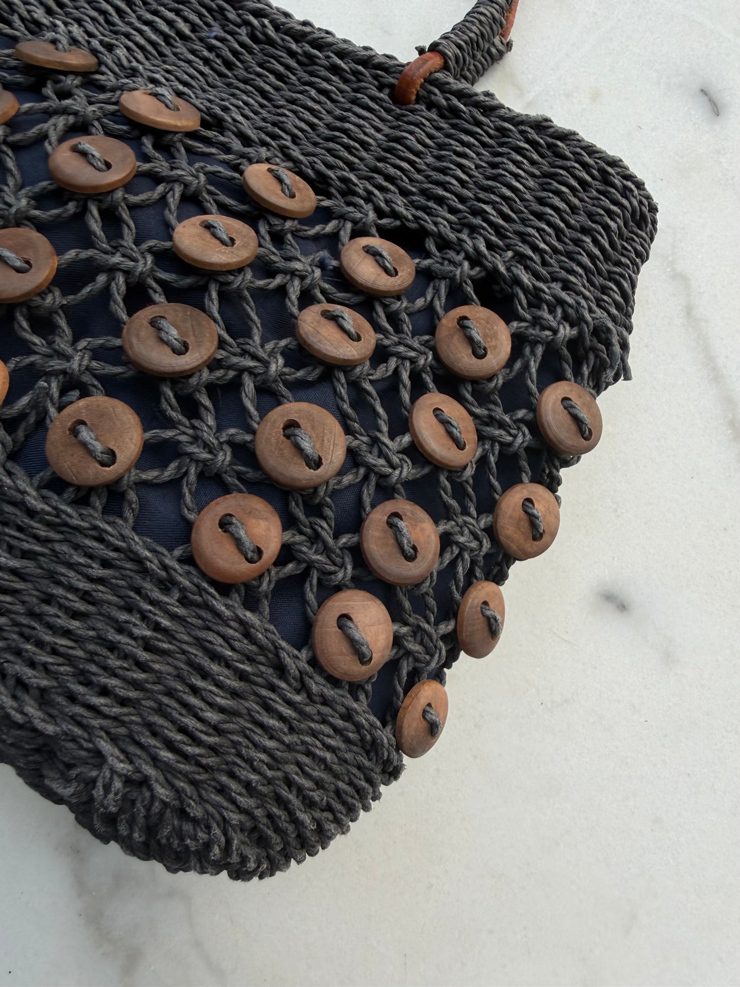 Vintage navy woven bag with wooden buttons and leather straps. Made in France